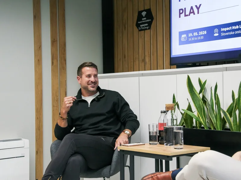 Guest Klemen Selakovič laughing while he answers a question on the stage at Impact Hub Ljubljana.